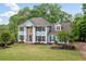 An elegant home with manicured lawn and landscaping, showcasing curb appeal and providing a welcoming entrance at 1039 Avery Creek Dr, Woodstock, GA 30188