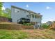 A lovely home with a tiered yard, deck and finished patio below offering ample outdoor space for relaxing and entertaining at 1039 Avery Creek Dr, Woodstock, GA 30188