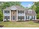 Beautiful traditional home with a manicured lawn, blue paint, and a striking stone accent around the front entrance at 1039 Avery Creek Dr, Woodstock, GA 30188