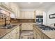 Spacious kitchen with stainless steel appliances, granite counters, tile backsplash, and an island cooktop at 1039 Avery Creek Dr, Woodstock, GA 30188