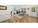 A kitchen with a center island cooktop and views to the outdoor living spaces at 1039 Avery Creek Dr, Woodstock, GA 30188