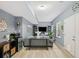 Living room features a couch, mini fridge, tv, table and a side entrance door at 1039 Avery Creek Dr, Woodstock, GA 30188