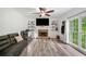 Comfortable living room featuring a fireplace, TV, ceiling fan, and natural light at 1039 Avery Creek Dr, Woodstock, GA 30188