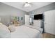 A spacious primary bedroom suite with a mounted TV, comfortable bed, and stylish decor, offering a private retreat at 1039 Avery Creek Dr, Woodstock, GA 30188