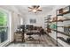 Stylish home office with built-in shelving, two computer monitors, and a cozy seating area for work from home at 1039 Avery Creek Dr, Woodstock, GA 30188