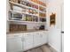 Organized walk-in pantry with ample shelving, countertops, and storage for all your kitchen needs at 1039 Avery Creek Dr, Woodstock, GA 30188