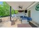 A covered patio with a ceiling fan, outdoor furniture, and a mounted TV, creating an ideal space for relaxing and entertaining at 1039 Avery Creek Dr, Woodstock, GA 30188