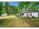 Beautiful backyard features a large lawn, mature trees, a storage shed, and a patio, perfect for outdoor activities at 1492 Frazier Rd, Decatur, GA 30033
