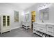 Bright bathroom featuring double vanity sinks, large mirrors, and natural light from large windows at 1492 Frazier Rd, Decatur, GA 30033