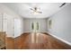 Large bedroom featuring hardwood floors, large windows, a ceiling fan, and a sliding glass door at 1492 Frazier Rd, Decatur, GA 30033
