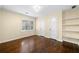 A bright bedroom with hardwood floors, a window, closet and shelving at 1492 Frazier Rd, Decatur, GA 30033