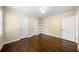 A bright bedroom with hardwood floors, two closets, and shelving at 1492 Frazier Rd, Decatur, GA 30033