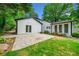 Charming home exterior boasts a stone patio, sliding glass doors, manicured lawn, and beautiful landscaping at 1492 Frazier Rd, Decatur, GA 30033