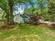 Classic home surrounded by mature trees, a sprawling lawn, and well-manicured landscaping provides a peaceful setting at 1492 Frazier Rd, Decatur, GA 30033