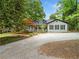 Charming single-Gathering home featuring a gravel driveway and a welcoming front porch at 1492 Frazier Rd, Decatur, GA 30033