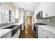 A bright modern kitchen featuring stainless steel appliances and white cabinetry at 1492 Frazier Rd, Decatur, GA 30033
