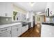 Modern kitchen with stainless appliances, white cabinetry, and stone countertops at 1492 Frazier Rd, Decatur, GA 30033