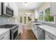 Modern kitchen featuring stainless steel appliances and mosaic tile backsplash at 1492 Frazier Rd, Decatur, GA 30033