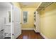 Walk-in closet featuring hardwood floors, a window, and modern shelving units at 1492 Frazier Rd, Decatur, GA 30033
