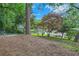 A lush backyard with mature trees and a gentle slope creates a peaceful and inviting outdoor space at 2685 Harrington Dr, Decatur, GA 30033