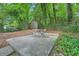 Backyard features a shed and patio with table and chairs, all surrounded by lush trees and greenery at 2685 Harrington Dr, Decatur, GA 30033