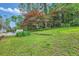 Expansive backyard featuring a well-maintained lawn, vibrant trees, and a patio area for outdoor relaxation and entertaining at 2685 Harrington Dr, Decatur, GA 30033
