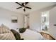 Comfortable bedroom with ensuite bathroom featuring hardwood floors, ceiling fan, and neutral décor at 2685 Harrington Dr, Decatur, GA 30033