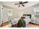 Bright bedroom featuring hardwood floors, ceiling fan, neutral colors, and comfortable furnishings at 2685 Harrington Dr, Decatur, GA 30033