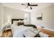 Bright bedroom with hardwood floors, ceiling fan, a large window, and neutral decor for a relaxing ambiance at 2685 Harrington Dr, Decatur, GA 30033