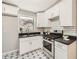 Well-lit kitchen with white cabinets, stainless steel appliances, subway tile backsplash, and patterned tile flooring at 2685 Harrington Dr, Decatur, GA 30033