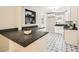 Modern kitchen with dark countertops, white cabinets, and patterned tile flooring at 2685 Harrington Dr, Decatur, GA 30033