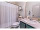 Well-lit bathroom features a vanity, toilet, and shower with decorative shower curtain and elegant finishes at 432 Creekside Park, Covington, GA 30014