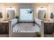 Bright bathroom with a soaking tub, double sinks, and plant decorations at 432 Creekside Park, Covington, GA 30014