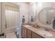 Bright bathroom with double vanity, round mirrors, and shower/tub combo at 432 Creekside Park, Covington, GA 30014