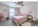 Bedroom with pink walls, ceiling fan, and decor at 432 Creekside Park, Covington, GA 30014
