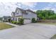 Spacious driveway leading to a two-car garage, surrounded by green trees and landscaping, offering ample parking at 432 Creekside Park, Covington, GA 30014