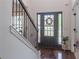 Welcoming front door with glass accents, foyer with hardwood floors and staircase, filling the space with natural light at 432 Creekside Park, Covington, GA 30014