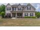 Charming two-story home with brick and gray siding, a welcoming front porch, and a well-manicured lawn at 432 Creekside Park, Covington, GA 30014