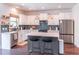 Modern kitchen features white cabinets, stainless steel appliances, a gray island and stylish backsplash at 432 Creekside Park, Covington, GA 30014