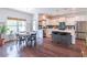 Bright, open kitchen with white cabinetry, island with bar seating, and a dining area with backyard views at 432 Creekside Park, Covington, GA 30014