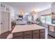 Kitchen island view into the living room with a fireplace, shelves, and lots of natural light at 432 Creekside Park, Covington, GA 30014