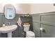 Stylish powder room with wainscoting, a decorative mirror, and modern fixtures, creating an elegant space at 432 Creekside Park, Covington, GA 30014