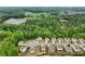 Aerial of homes near lush green space and horse farms and other agricultural buildings and mature trees at 4615 Elmwood Trl, Cumming, GA 30028