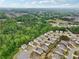 Aerial view of the neighborhood and the surrounding green landscape and wooded areas at 4615 Elmwood Trl, Cumming, GA 30028