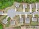 Bird's eye view of homes on a cul-de-sac with manicured lawns, long driveways and mature trees at 4615 Elmwood Trl, Cumming, GA 30028