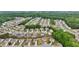 Expansive aerial view of a residential community nestled amongst lush greenery and mature trees at 4615 Elmwood Trl, Cumming, GA 30028