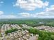 Beautiful community aerial with mountain views and mature trees under a bright blue, cloudy sky at 4615 Elmwood Trl, Cumming, GA 30028