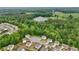 Aerial of homes near lush green space and horse farms and other agricultural buildings and mature trees at 4615 Elmwood Trl, Cumming, GA 30028