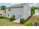 Backyard featuring a sliding glass door and patio space, surrounded by green bushes at 4615 Elmwood Trl, Cumming, GA 30028