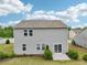 Exterior of a home showcasing a gray vinyl siding with a sliding glass door to the backyard at 4615 Elmwood Trl, Cumming, GA 30028